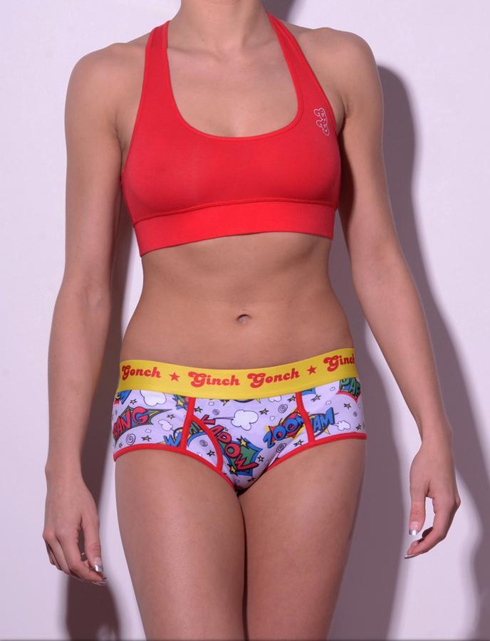 GG Ginch Gonch Under-Man Y front boy cut Brief - women's Underwear comic-inspired print on gray background with cartoon words. Red trim and yellow printed waistband front shown with red sports bra