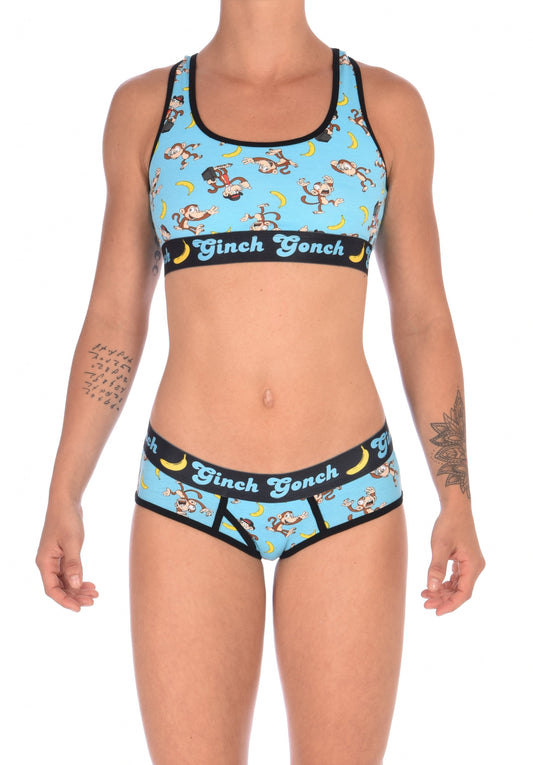 Ginch Gonch Monkey Business Women's Underwear boy cut brief with y front, with blue background, monkeys, and bananas. Black trim and printed waistband with Ginch Gonch and bananas. Front. Matching Sports bra